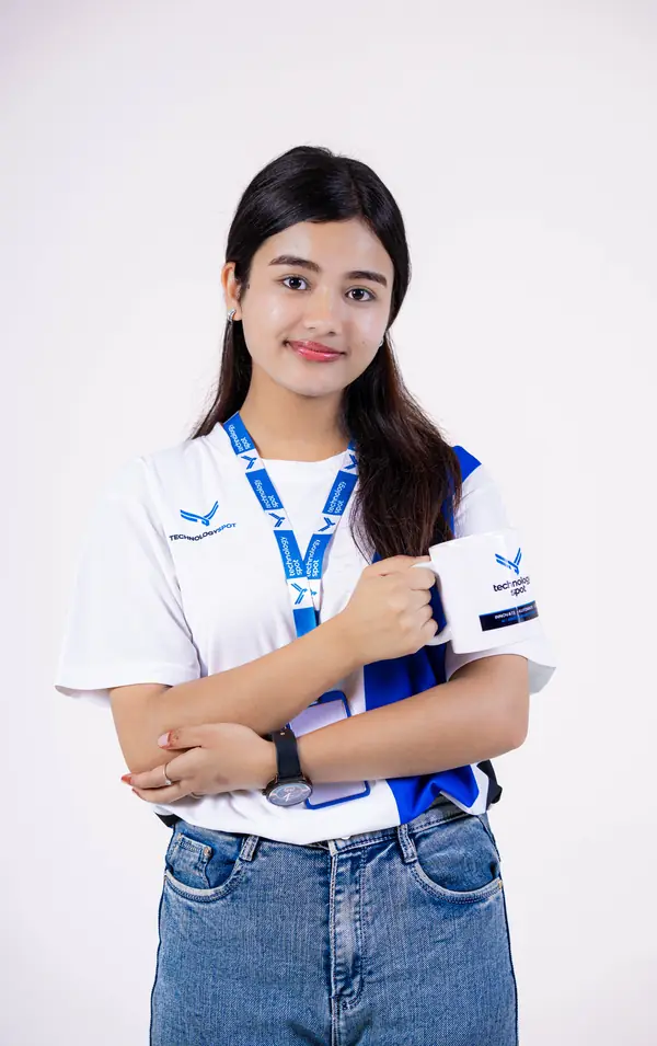 A Technology Spot digital marketing specialist holding a branded mug
