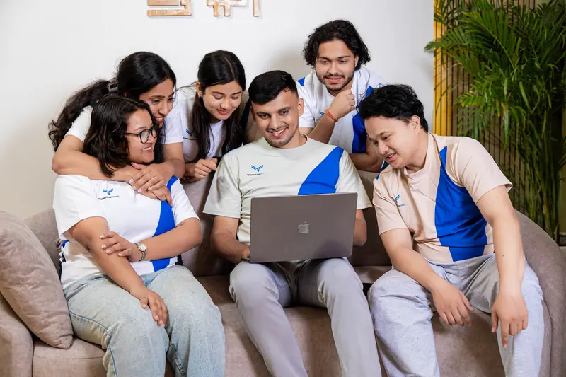 Social media marketing team reviewing content on a laptop
